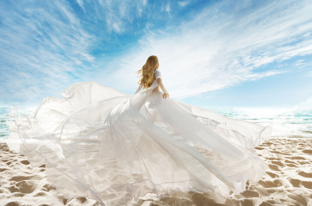 Bride in gown on beach